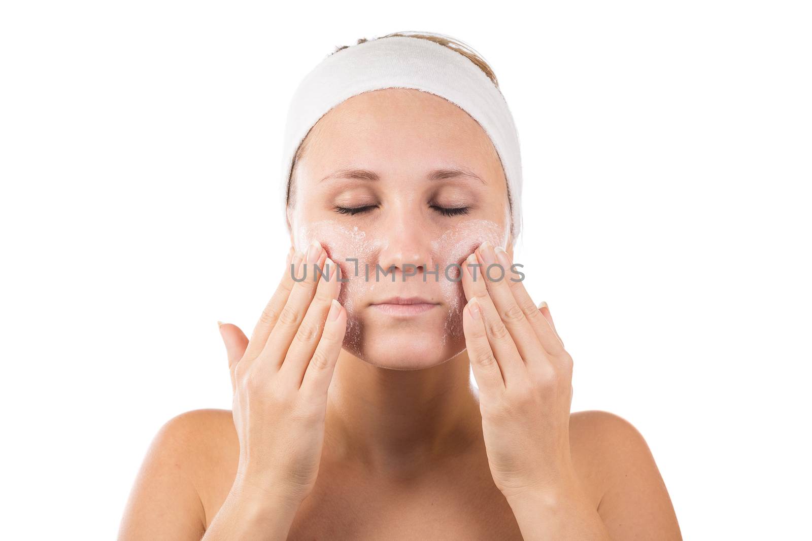 A young girl makes a face mask.