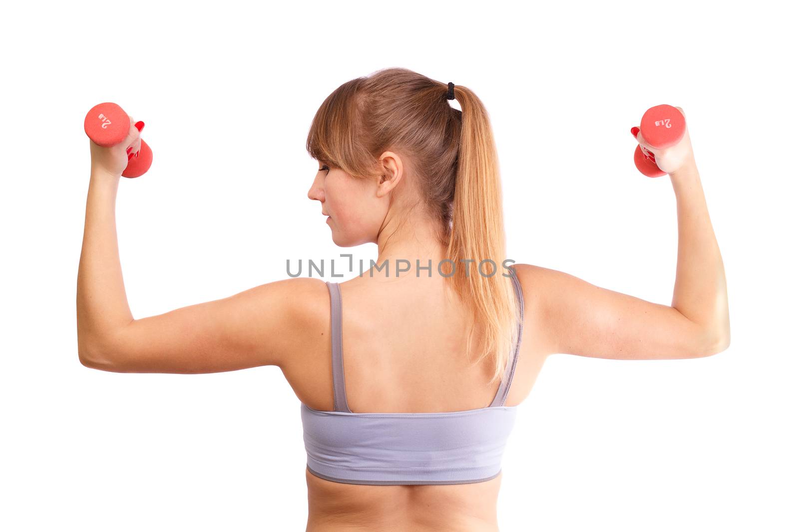 The girl goes in for sports with dumbbells on a white background.