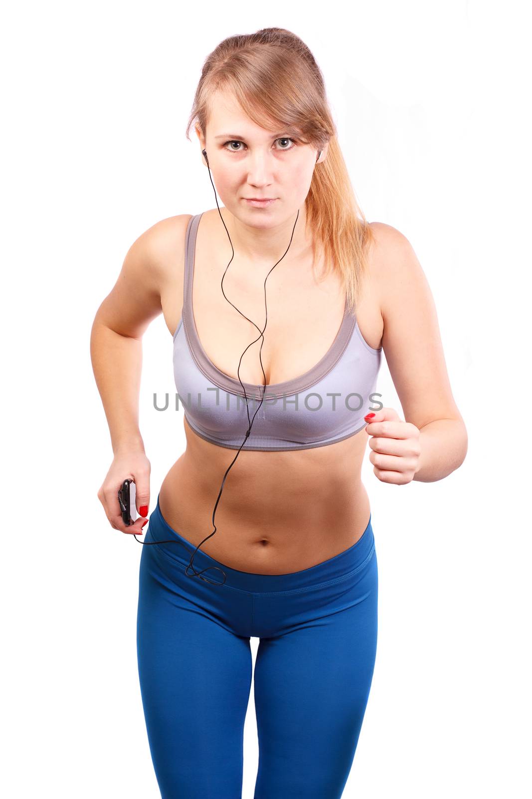 Woman runs on a white background, in her ears headphones.