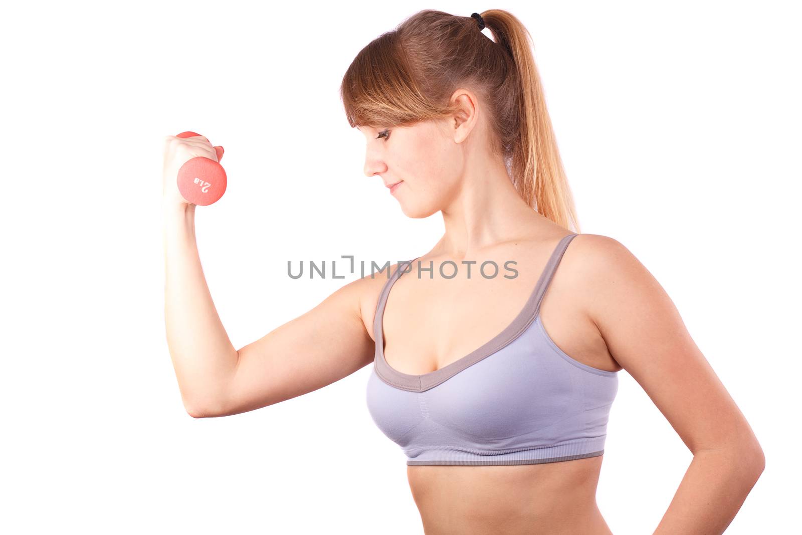 The girl goes in for sports with dumbbells on a white background.