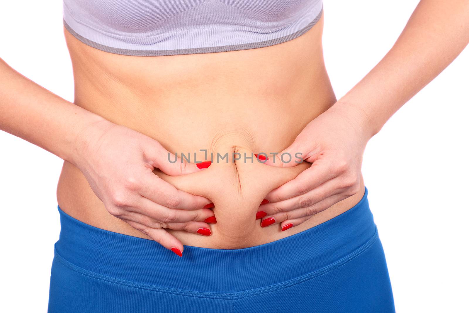 The girl goes in for sports in the studio on a white background.