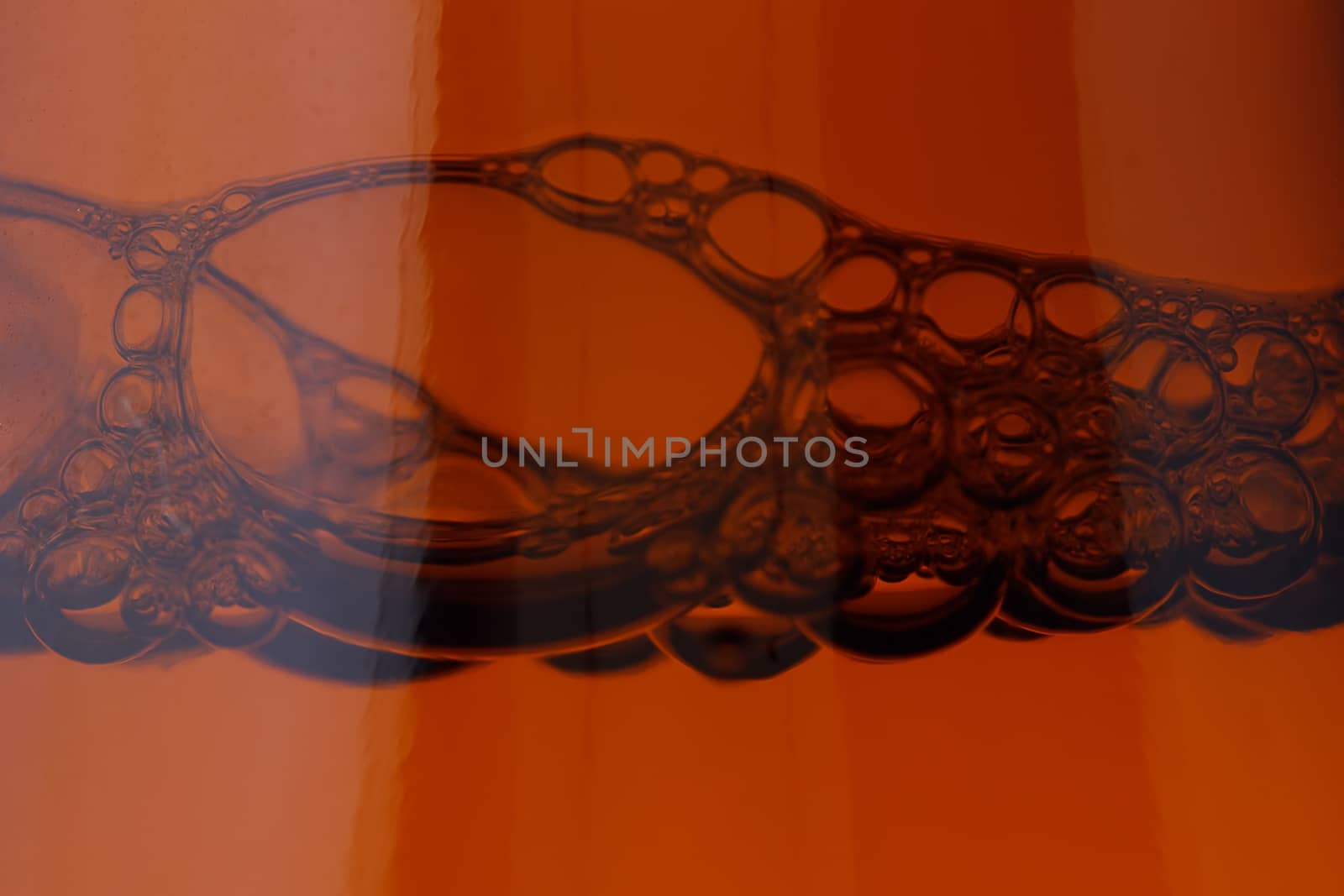 Closed, brown beer bottle on a white background.