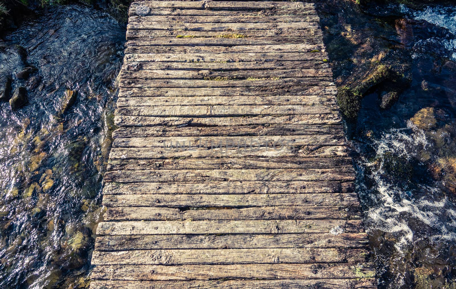 Conceptual Image Of A Rickety Wooden Footbridge Over A Stream Or Creek Or Brook In Scotland