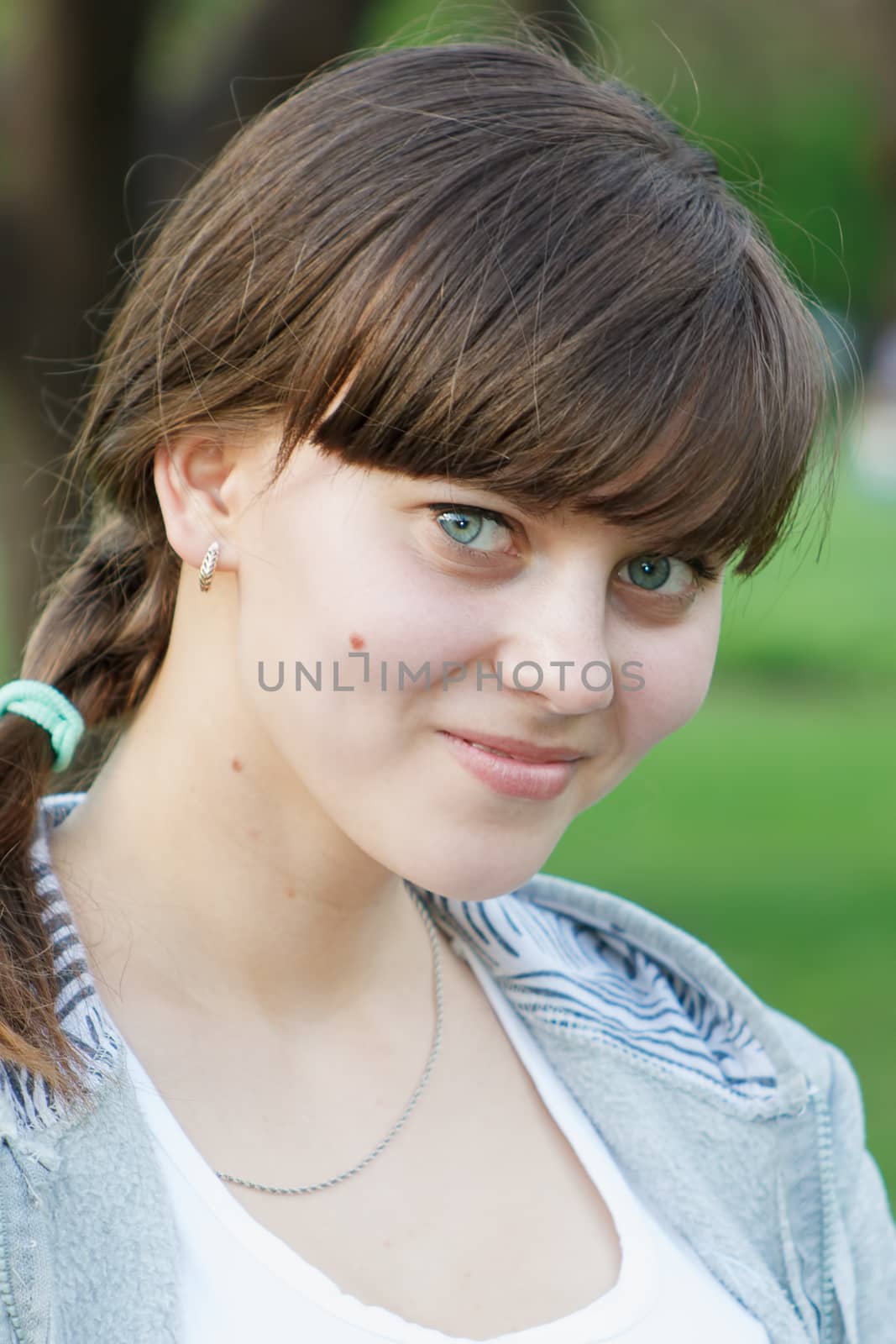 Portrait of pretty young girl outdoors.