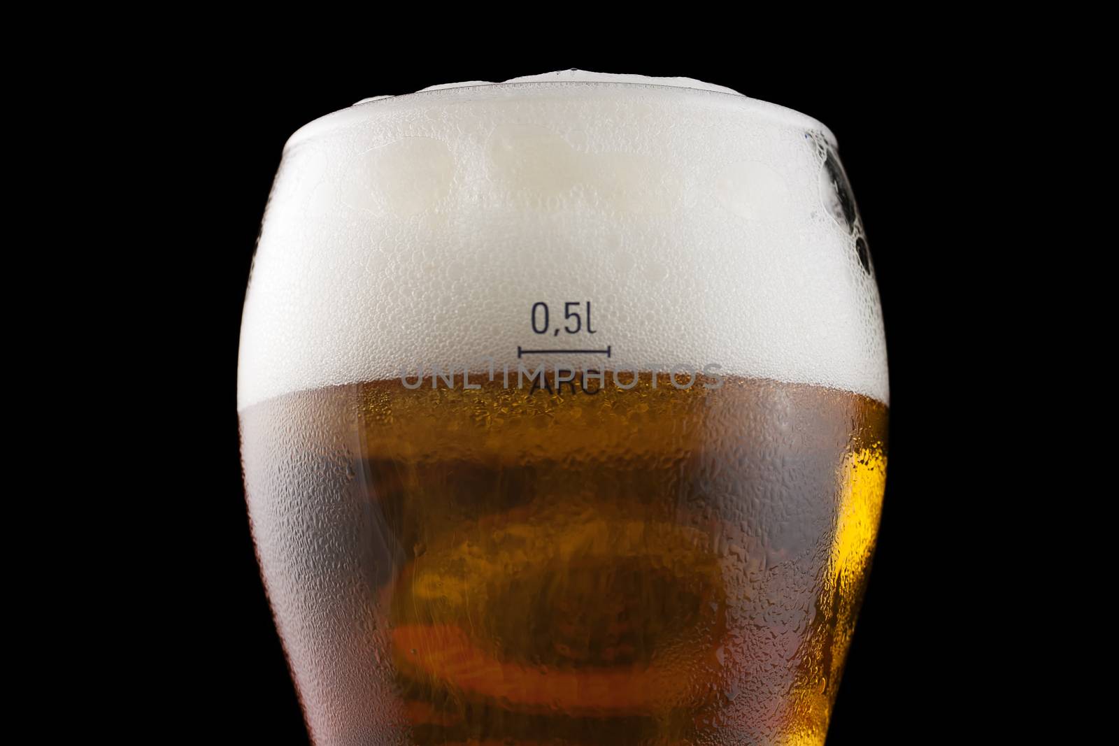 Glass of cold beer on a black background.