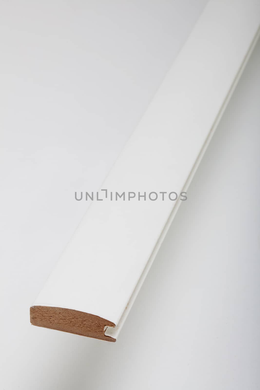 white long molding made of mdf, on white surface