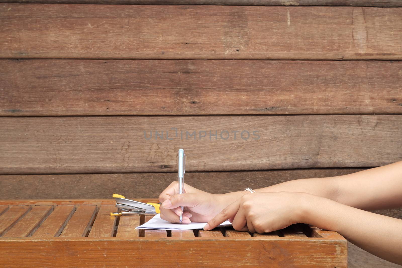 Signing Official Document, Person writing on a document.