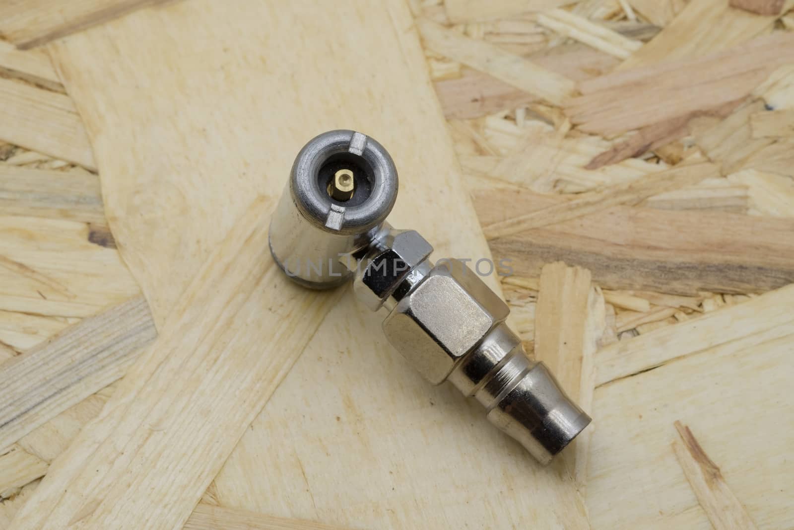 Air coupling connector, Pneumatic fitting on wood background.