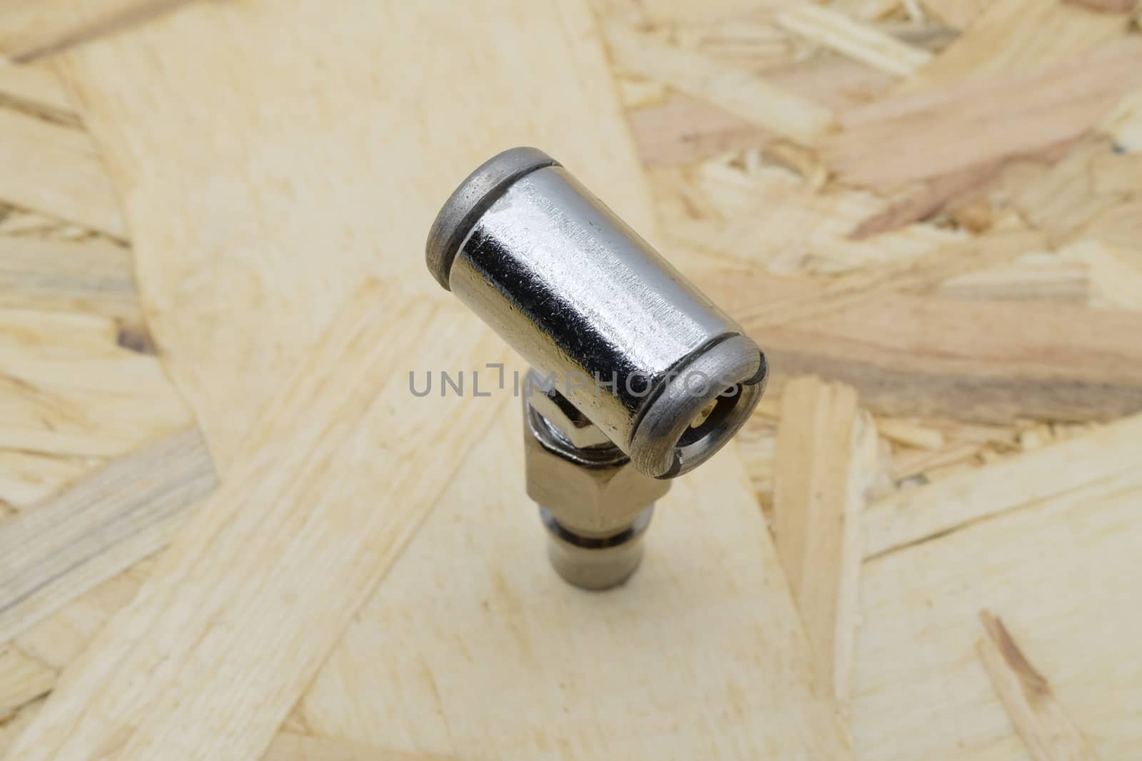 Air coupling connector, Pneumatic fitting on wood background.