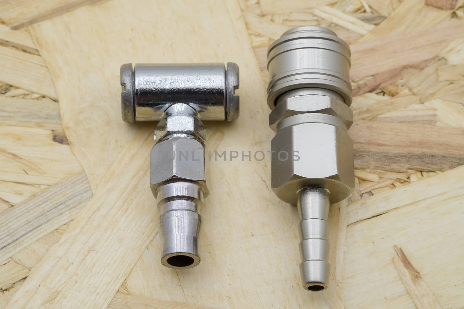 Air coupling connector, Pneumatic fitting on wood background.