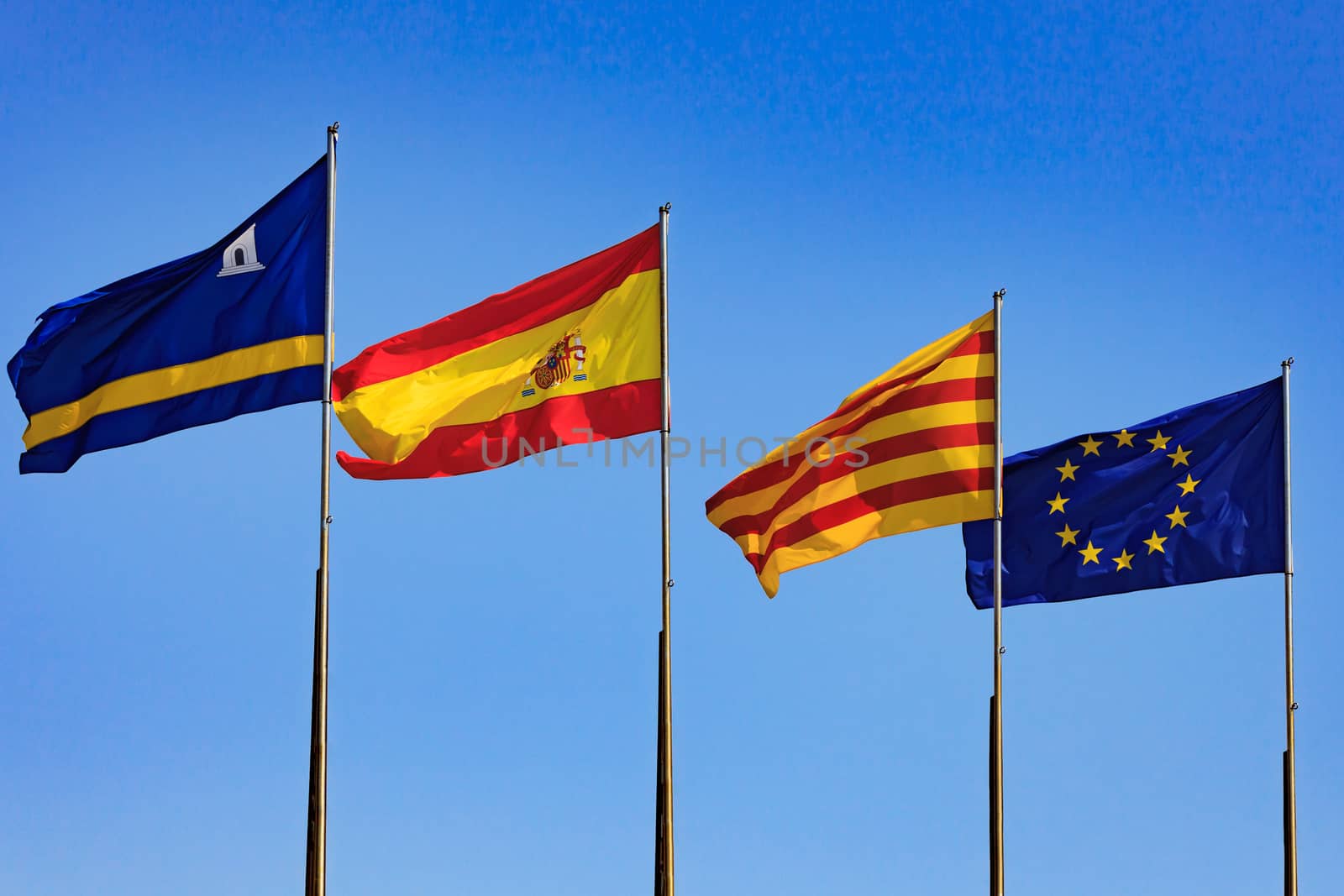 Flags of Spain, Salou, Catalonia, European Union against blue sky