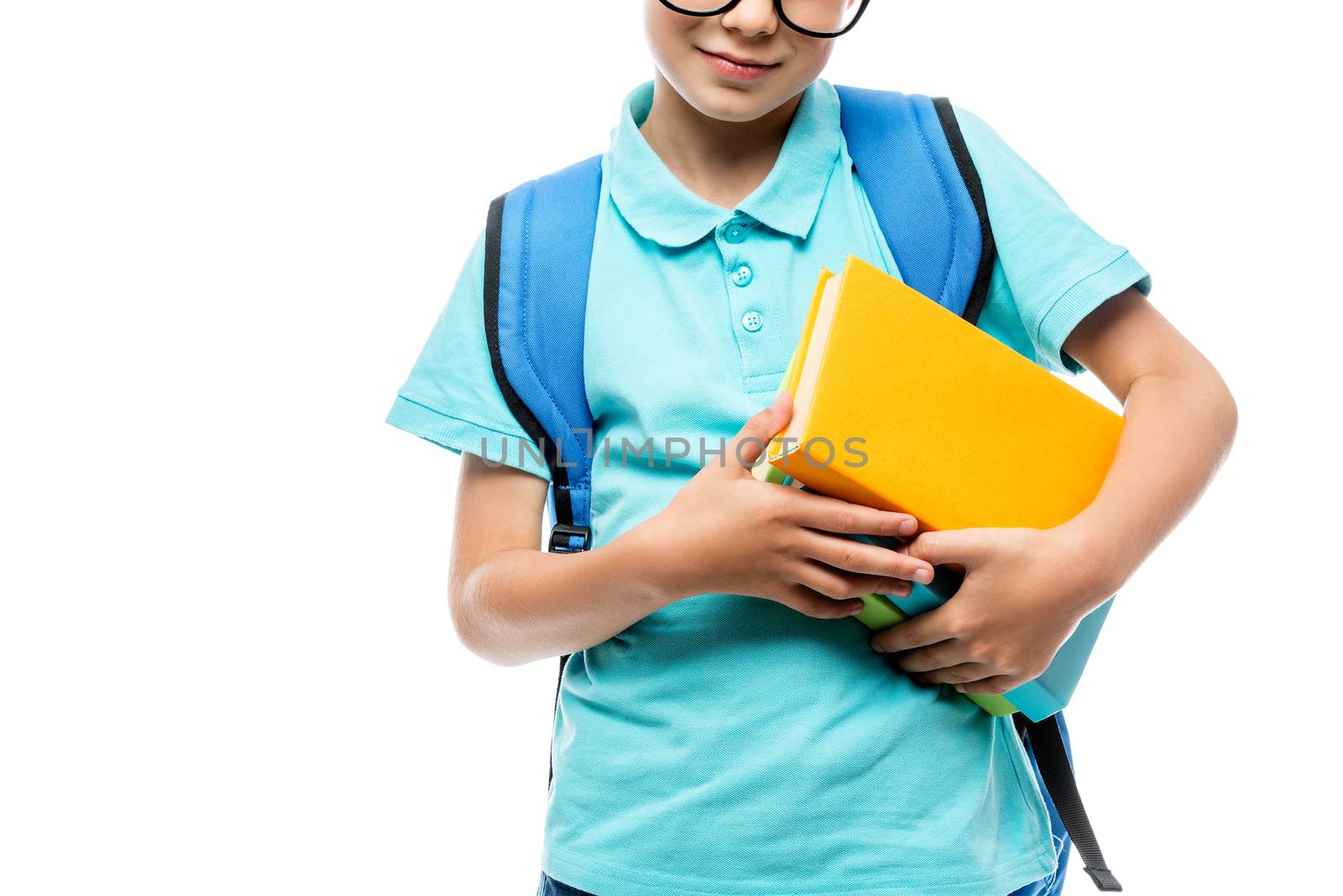 close-up of a schoolboy's hand holding a pile of books isolated by kosmsos111