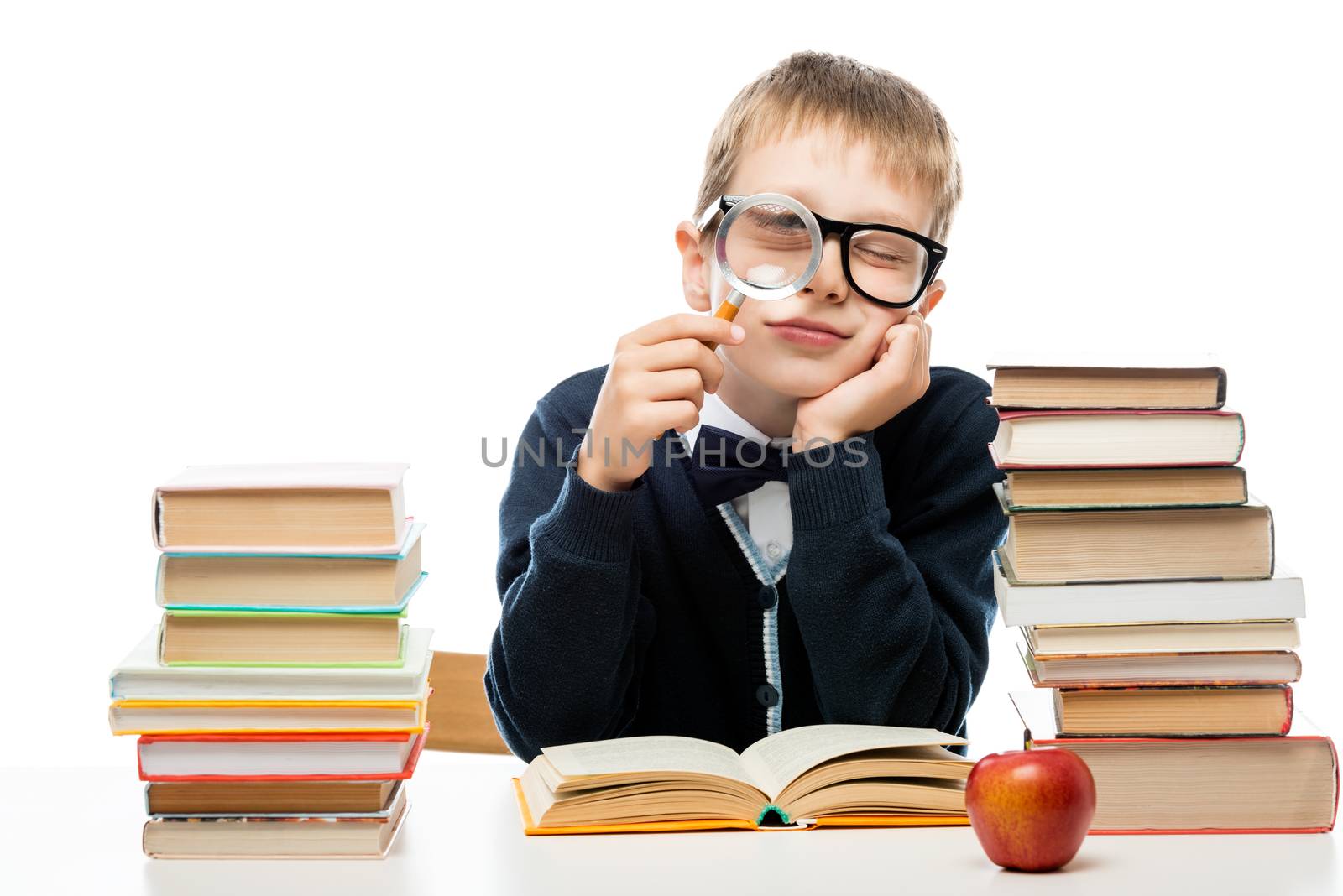 boy with magnifier at the table with a pile of books on a white by kosmsos111