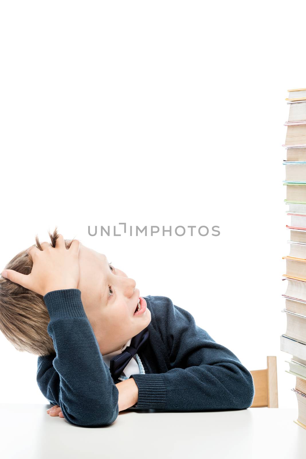 a large pile of books to read on the table and a portrait of a surprised schoolboy