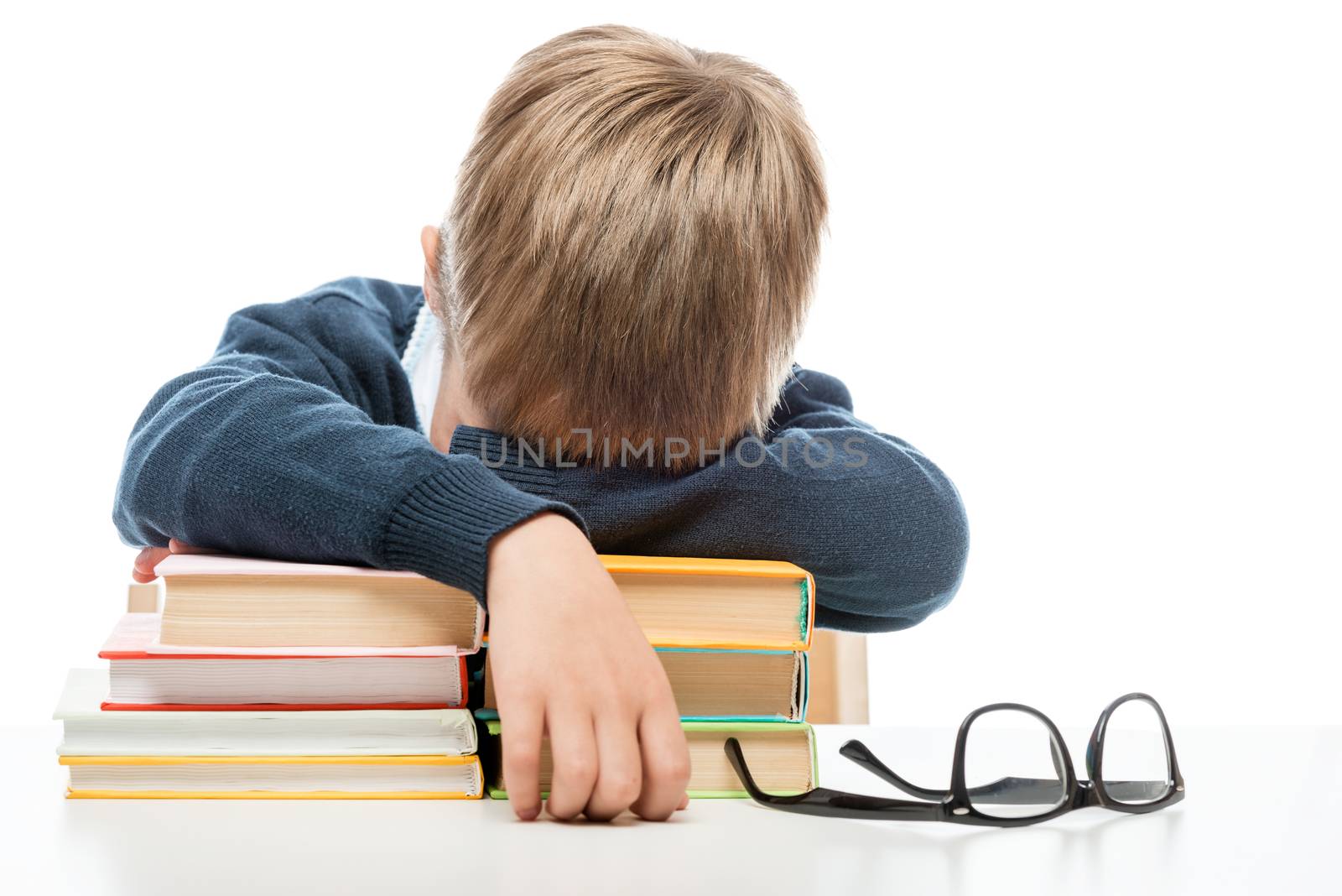 the schoolboy fell asleep on the books during the lesson at the table