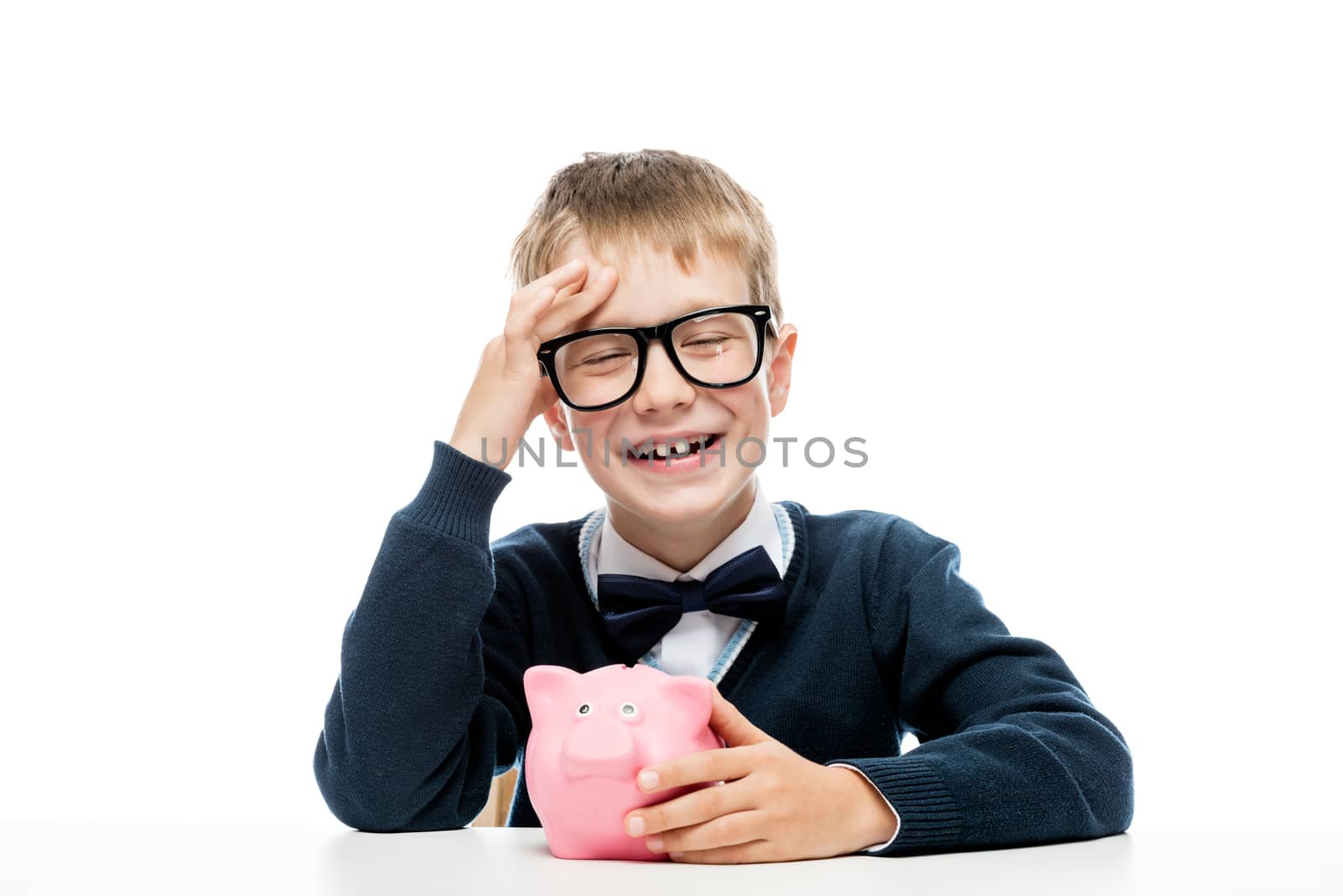 cheerful boy in glasses with a piggy bank on a white background