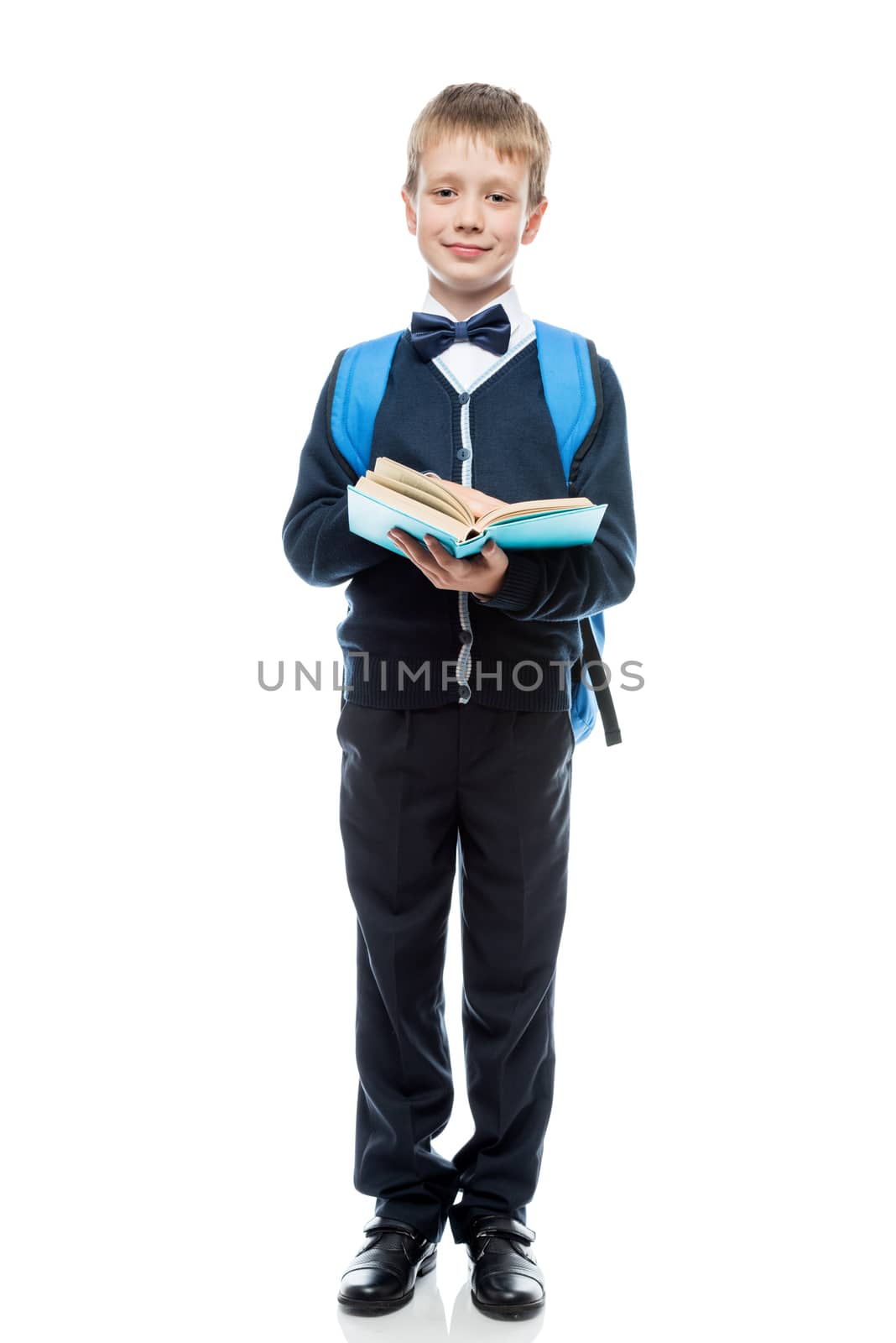 happy schoolboy with textbook and backpack on a white background by kosmsos111