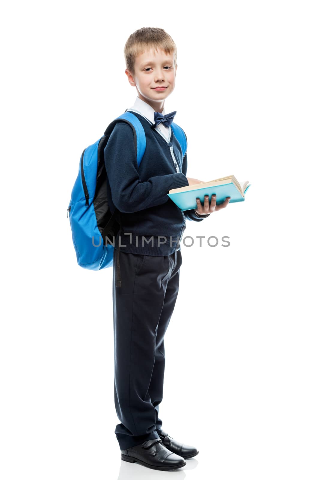 schoolboy with a book and a backpack in the studio on a white ba by kosmsos111