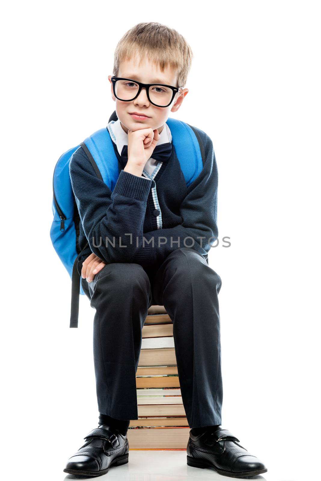 portrait of a schoolboy with glasses sitting on a pile of books by kosmsos111