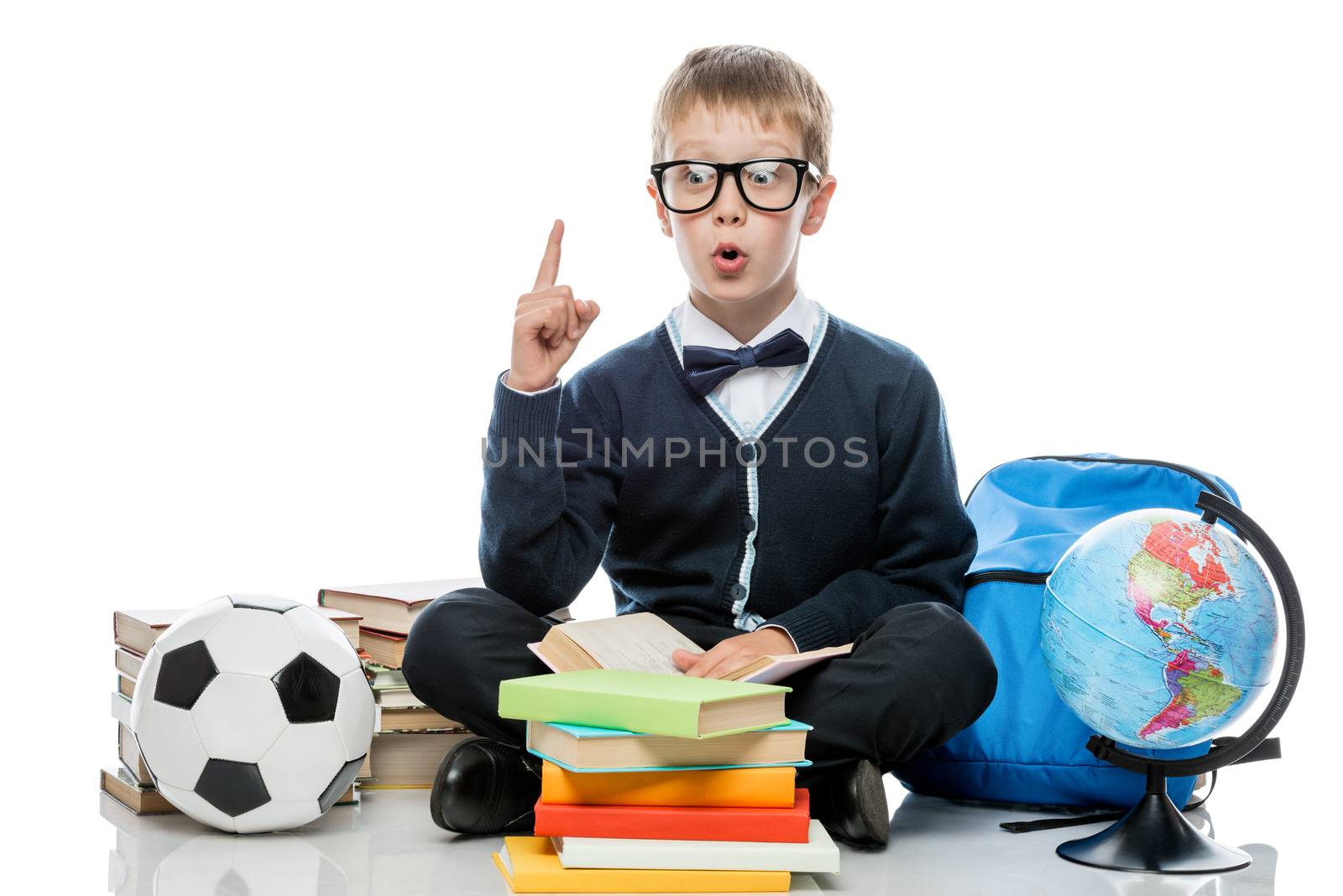 a small schoolboy makes new discoveries, a portrait on a white background