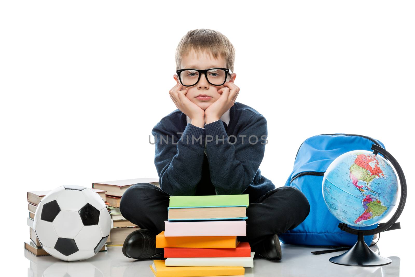 horizontal portrait of a schoolboy with books and globe on a whi by kosmsos111