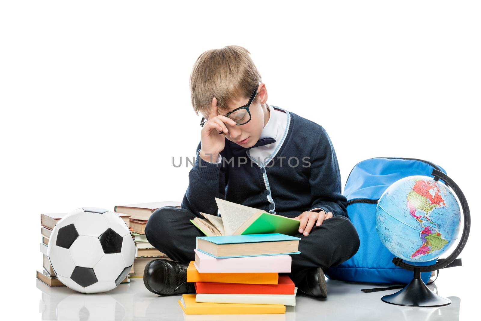 tired student with a book posing on a white background in the studio