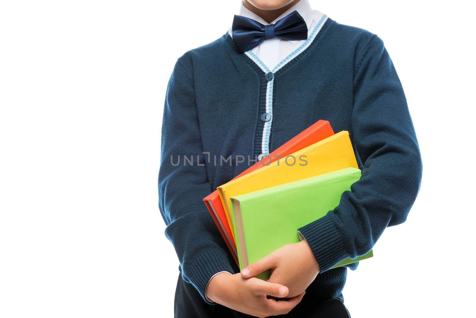 schoolboy in uniform with books on white background