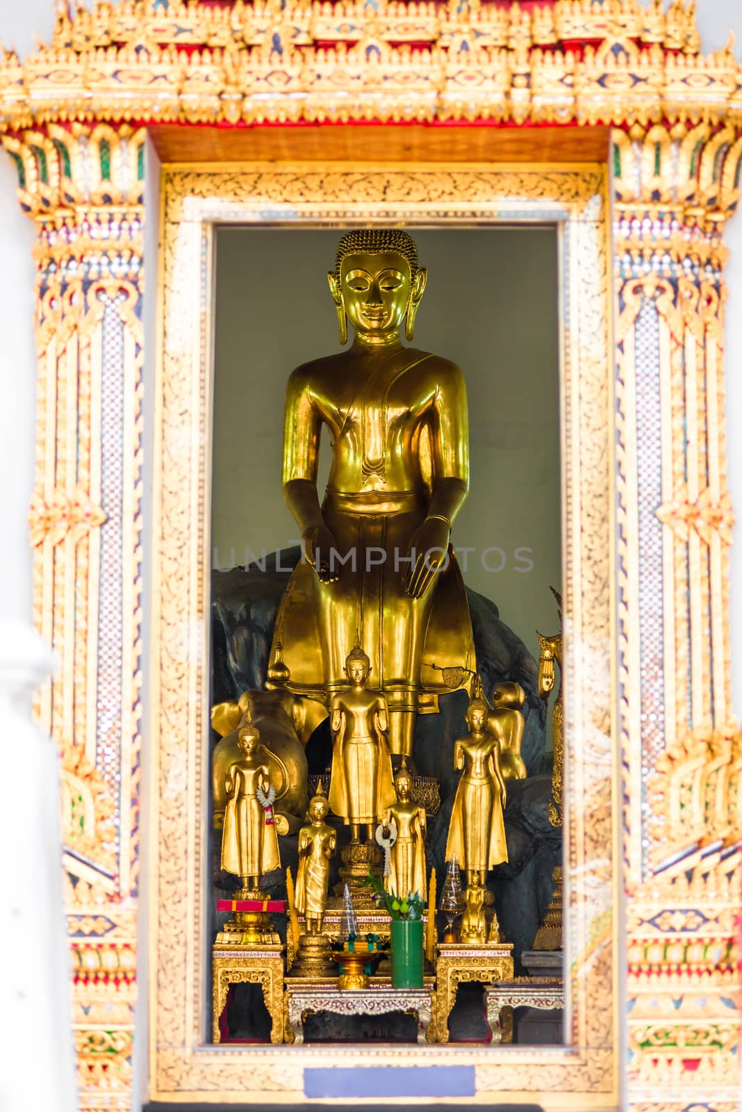 golden Buddha in the temple, view from the street