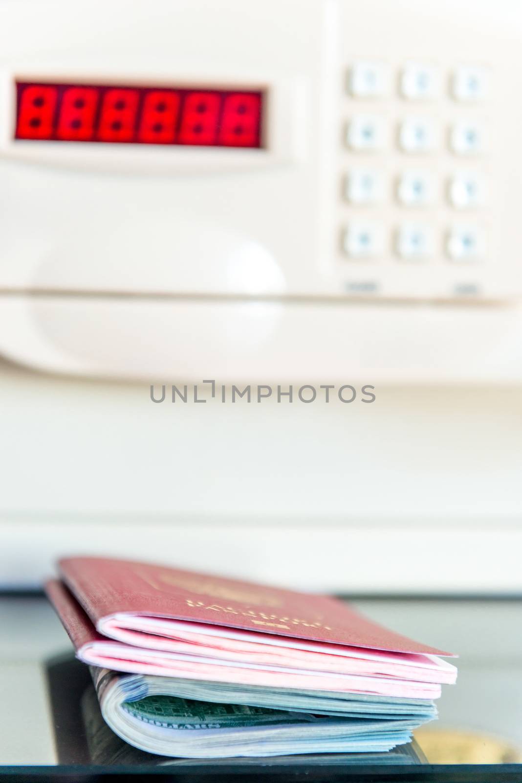 Passports of travelers and money on the background of the safe in the hotel