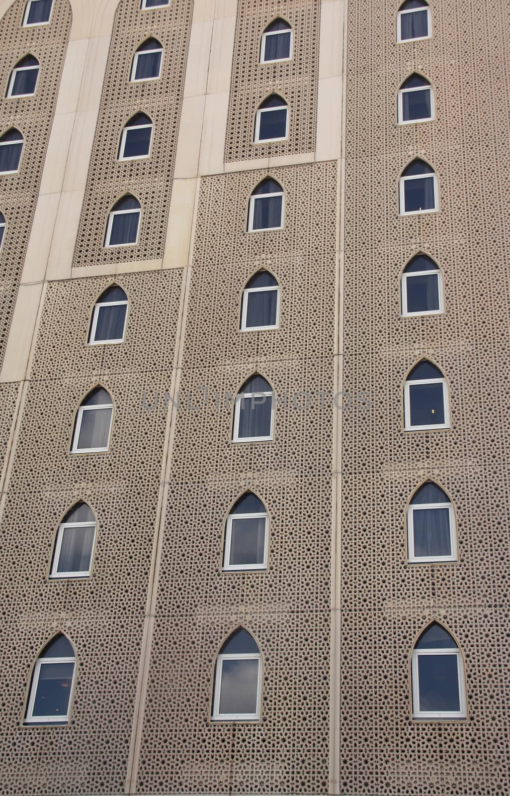 The windows on the exteriors of a building with traditional Islamic architecture.