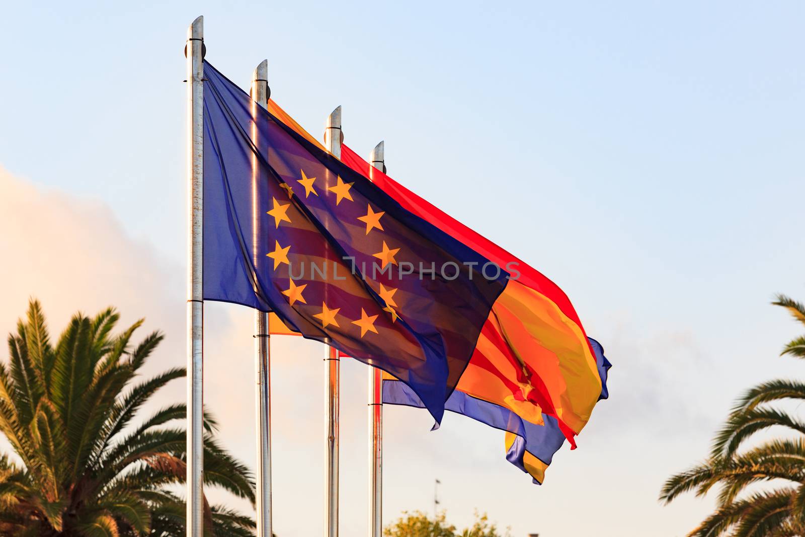 Flags of Spain, Salou, Catalonia, European Union against blue sk by Nobilior