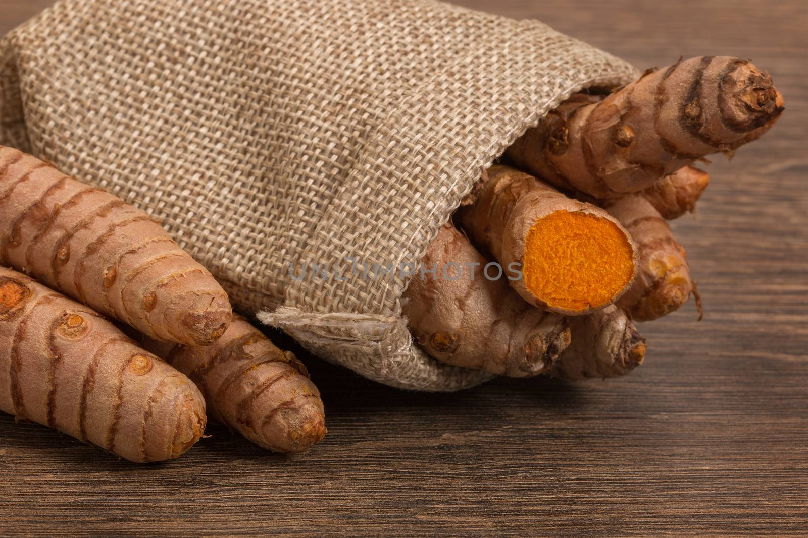 stack of turmeric on grunge wooden background by ivo_13