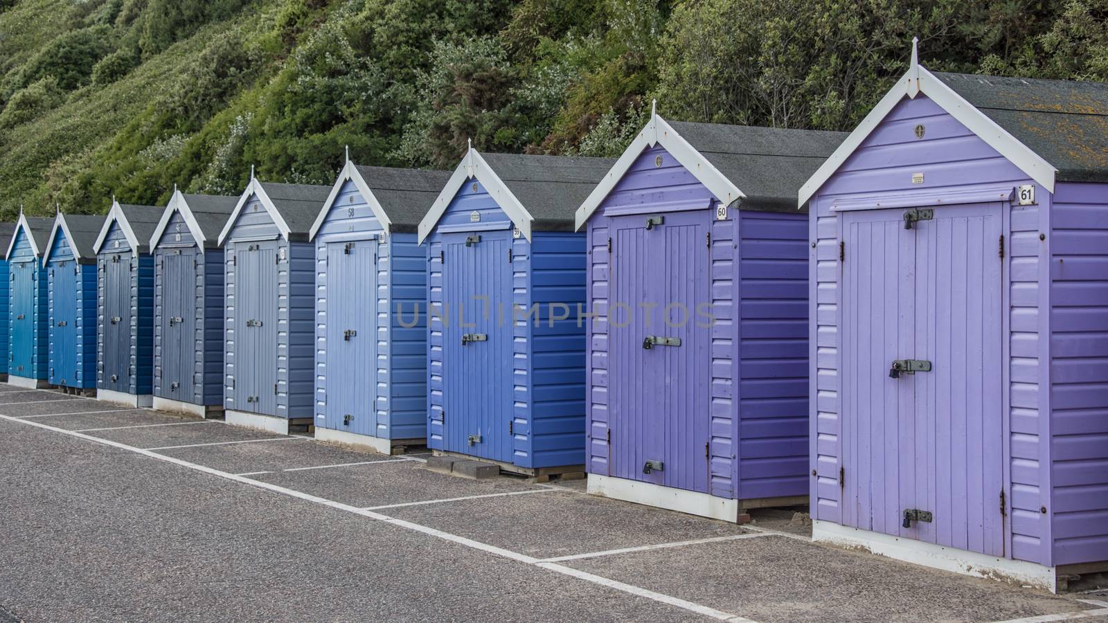 Colorful beach huts by alan_tunnicliffe