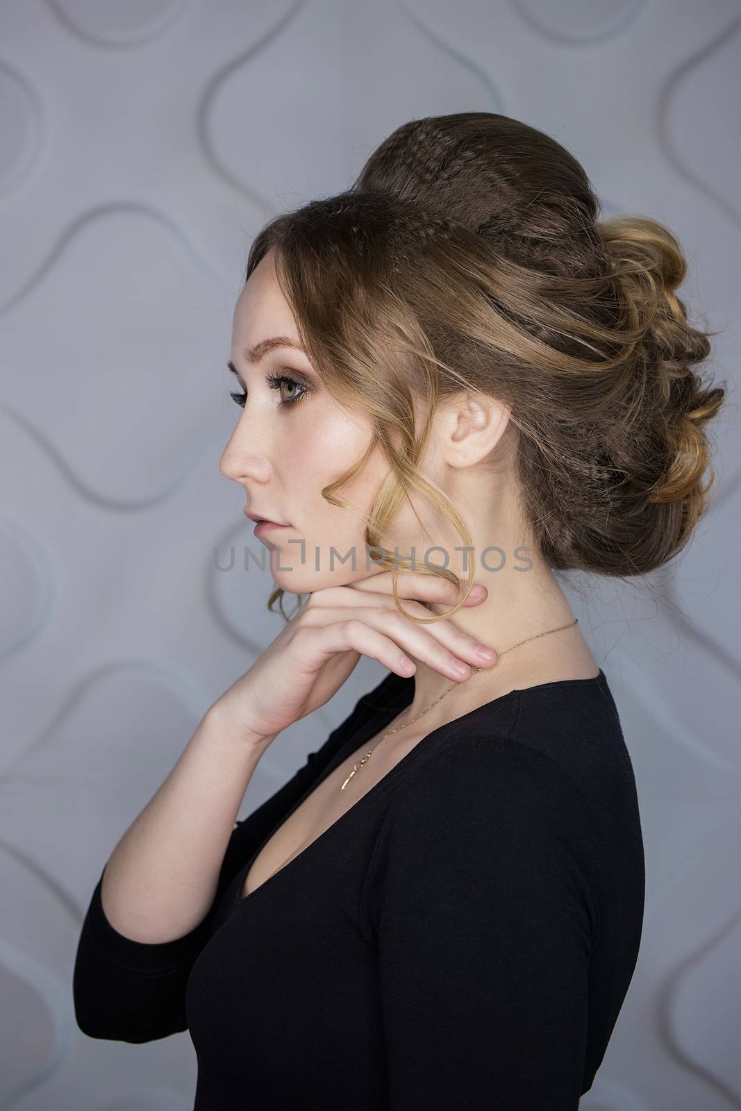 Brunette girl with long and shiny wavy hair . Beautiful model with curly hairstyle by 3KStudio