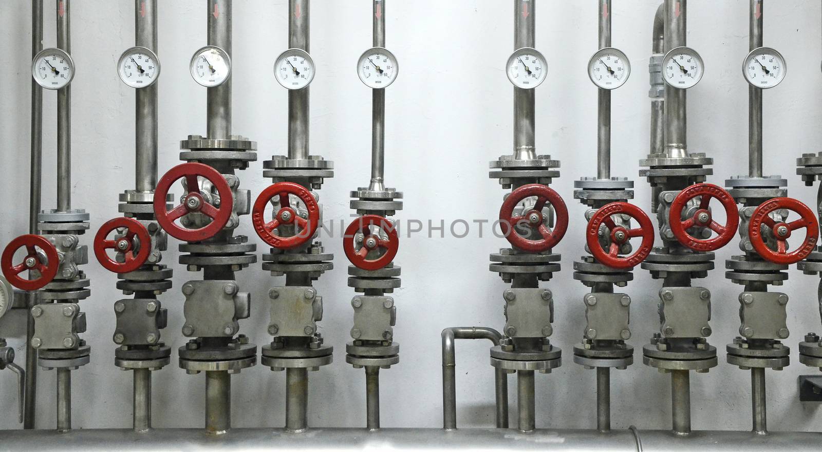 Colorful valves in industrial plant on pipes