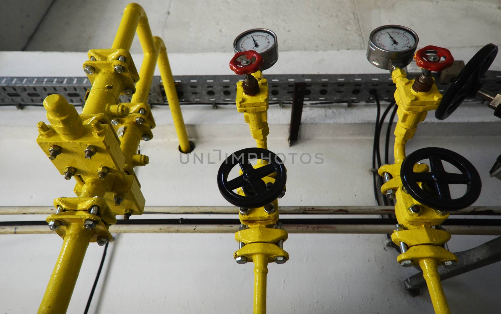 Colorful valves in industrial plant on pipes