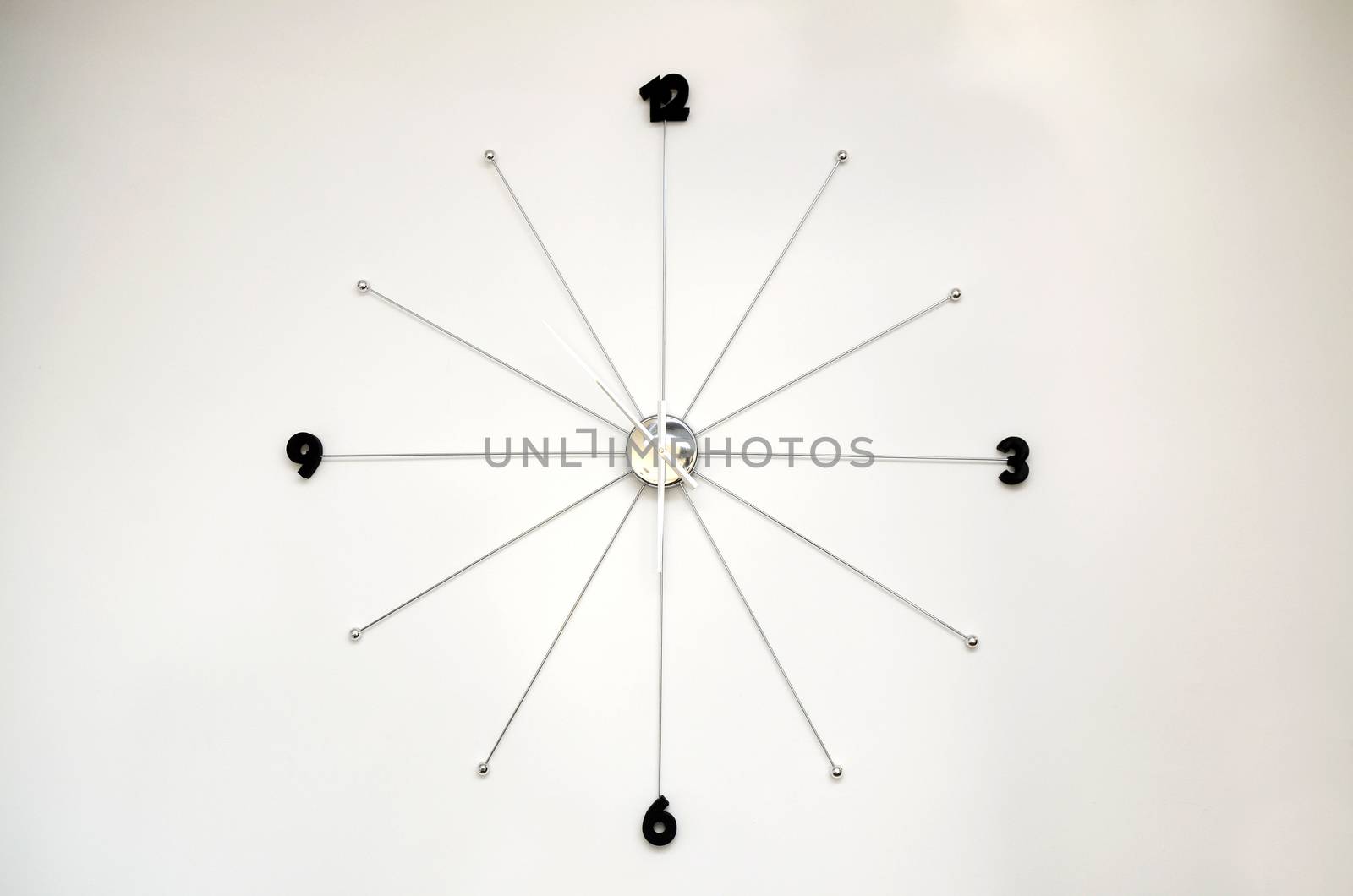 Silver Modern wall clock on white wall
