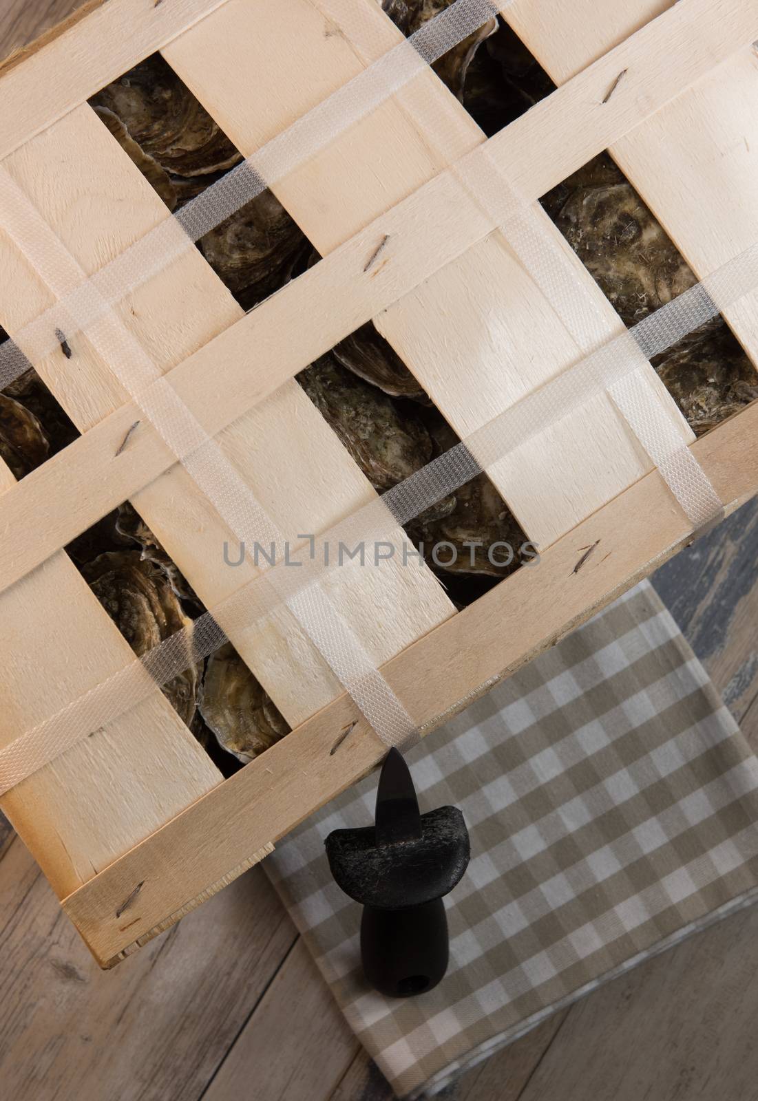 Raw oysters with lemon on wood board and bottle of wine and glass, France
