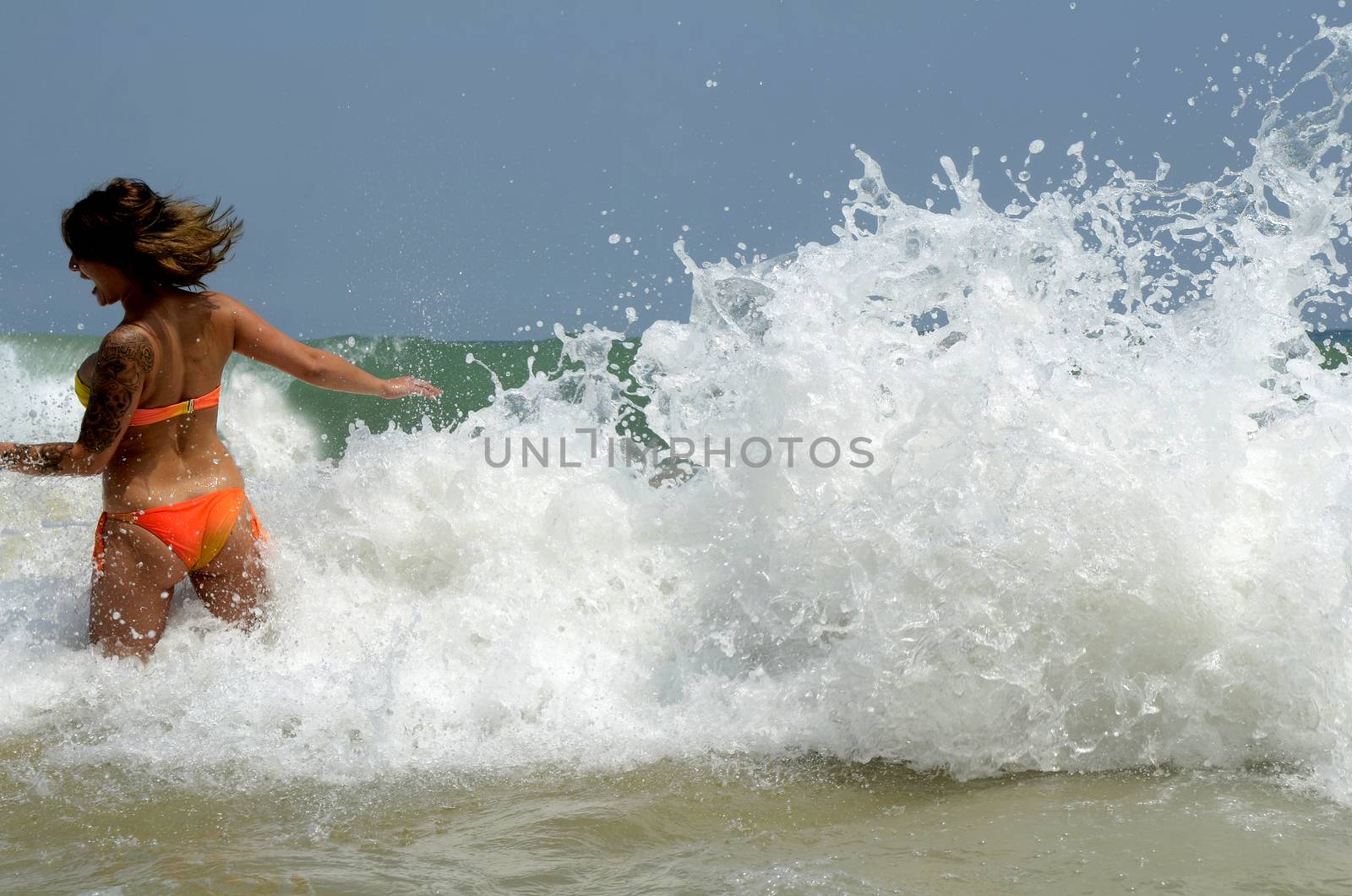 Waves on the beach on sunny summer day
