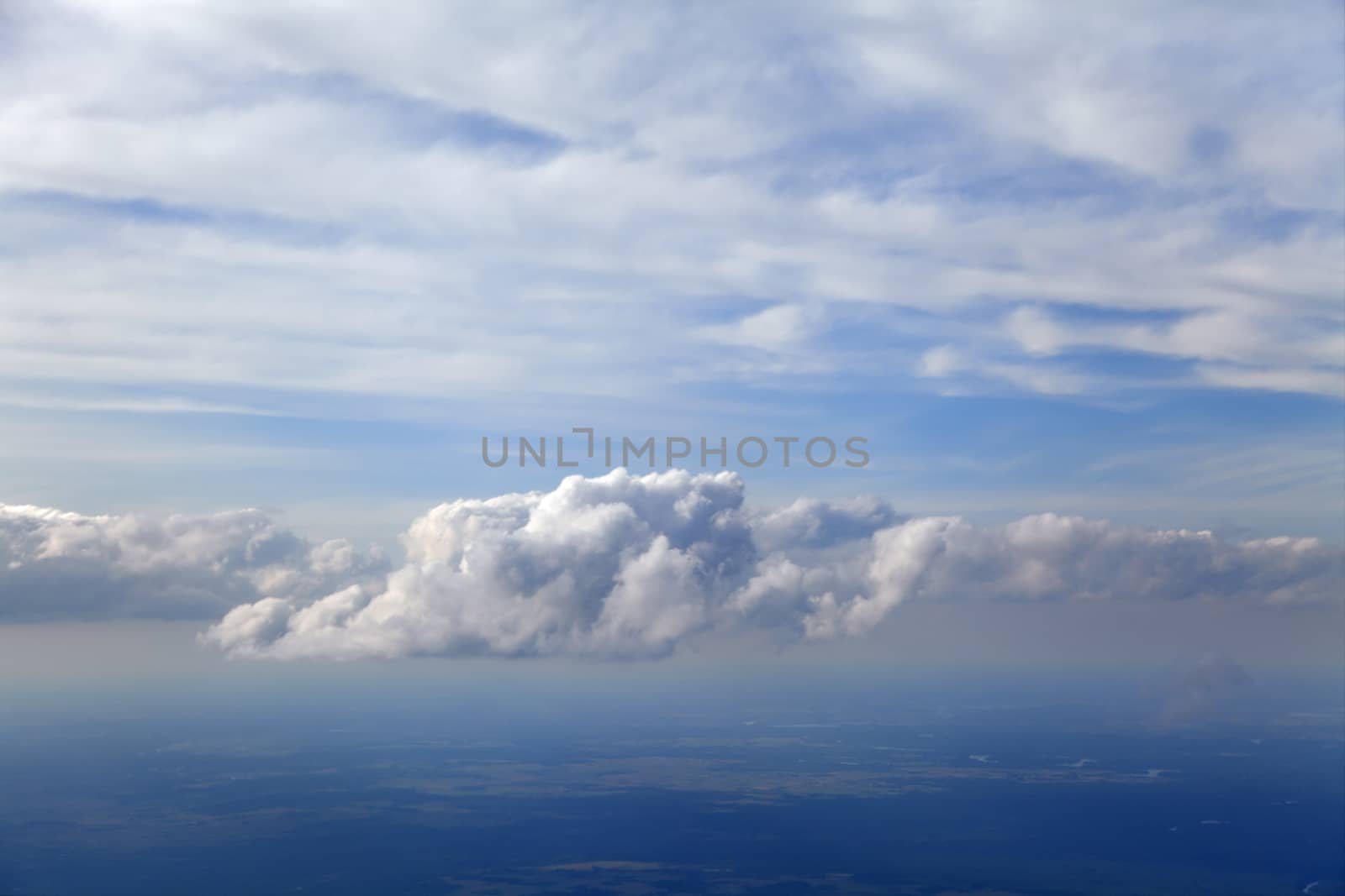 Blue and silver clouds background, view from airplane