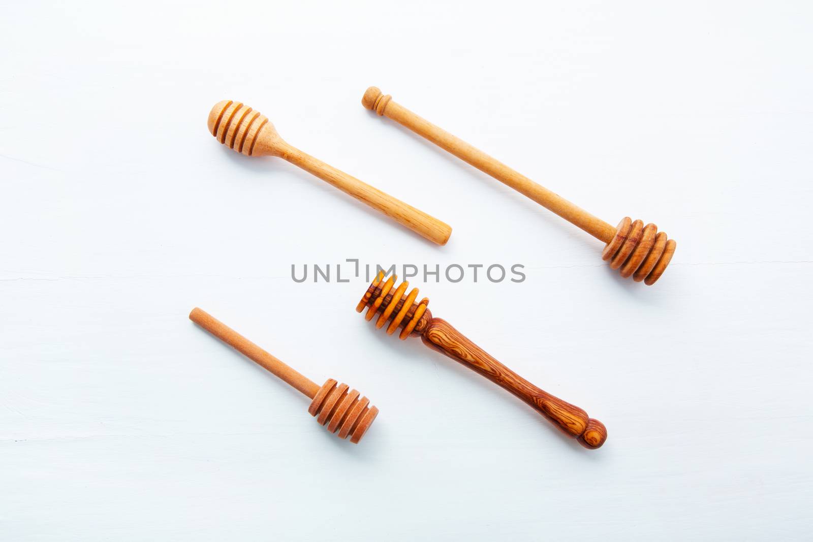 Wooden honey stick isolated on white wooden background,  by Bowonpat