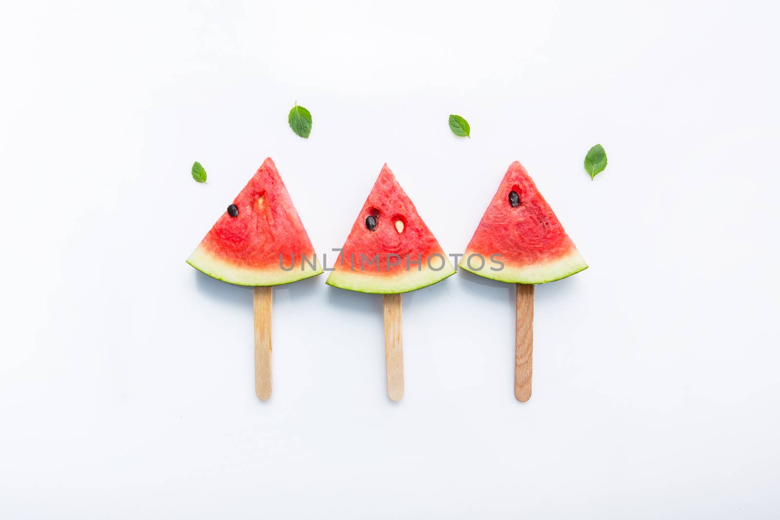 Watermelon slice popsicles on white background