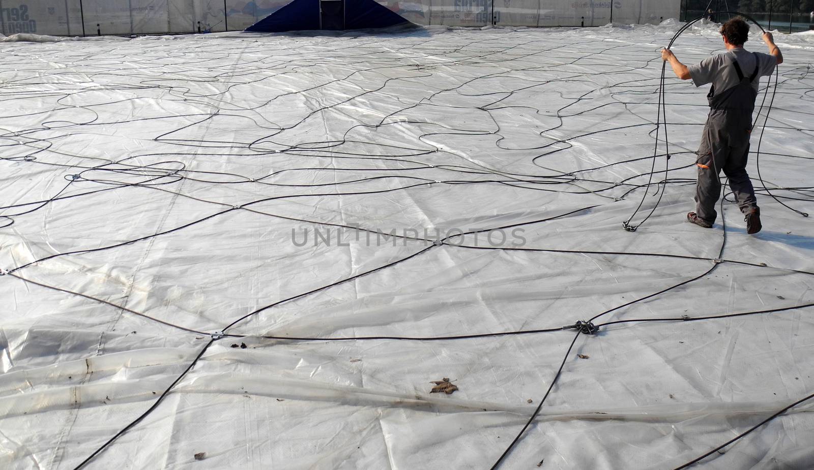 Worker with a lot of cables on construction site