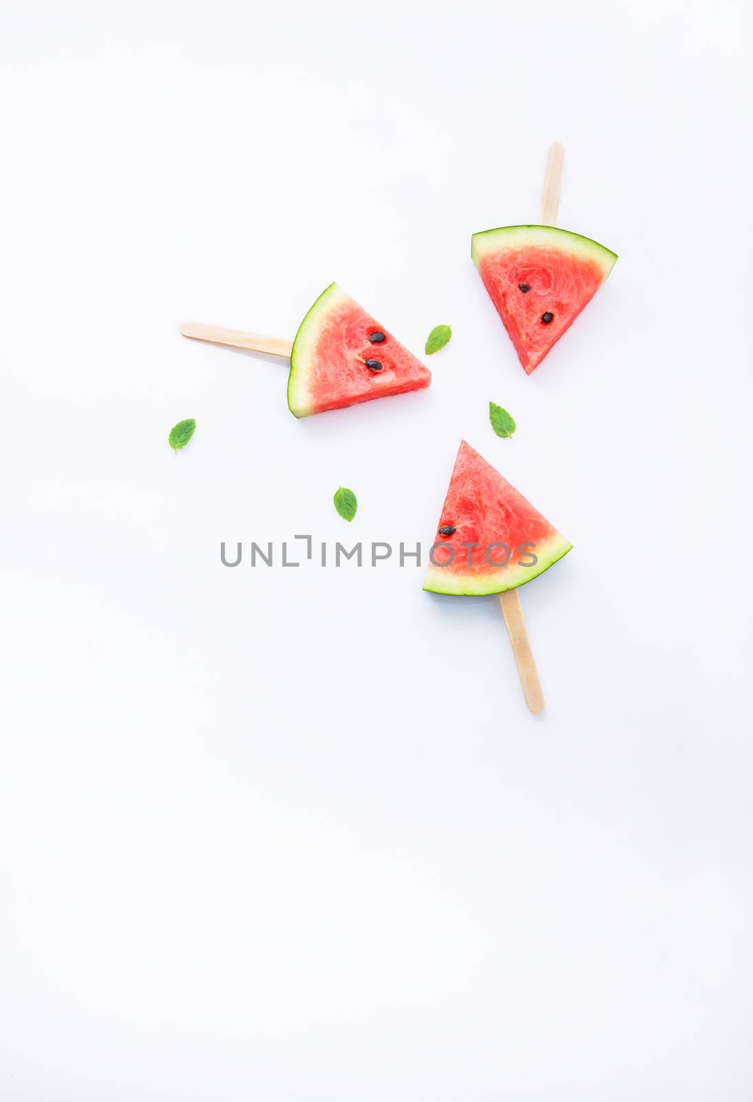 Fresh and sweet watermelon slice popsicles on white background