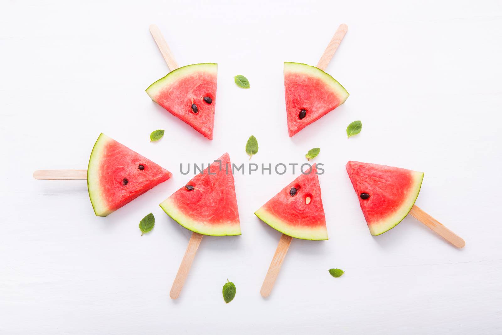 Watermelon slice popsicles on white background by Bowonpat