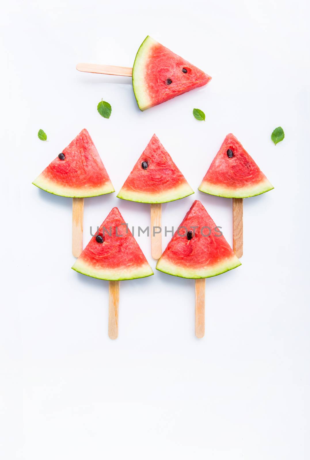 Fresh and sweet watermelon slice popsicles on white background