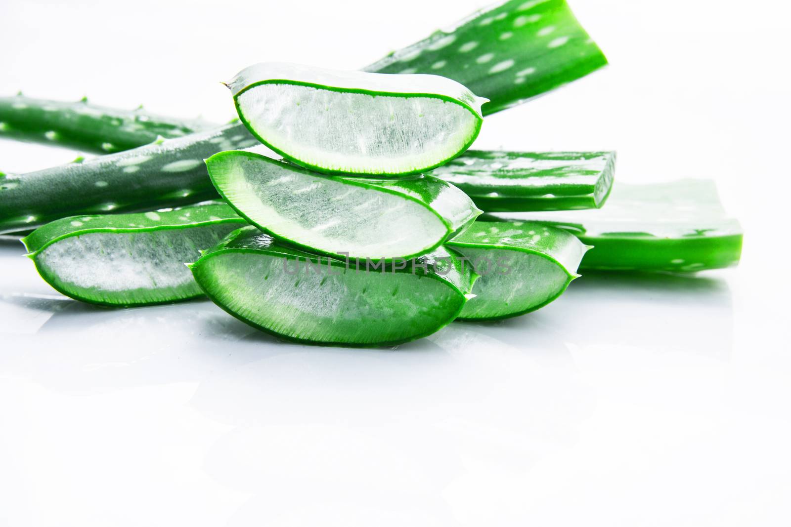 Aloe vera fresh leaves with slices aloe vera gel. isolated over white with copy space.