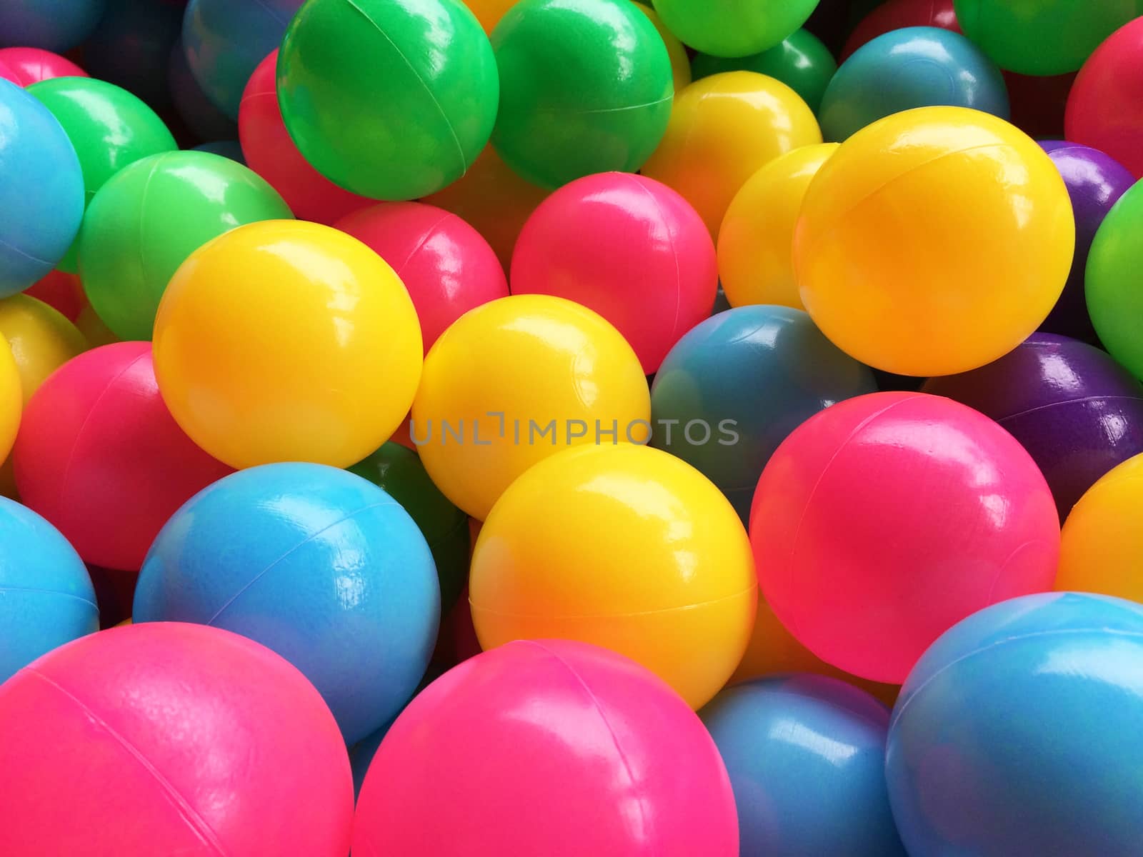 dry children's pool with colorful balls by Bowonpat