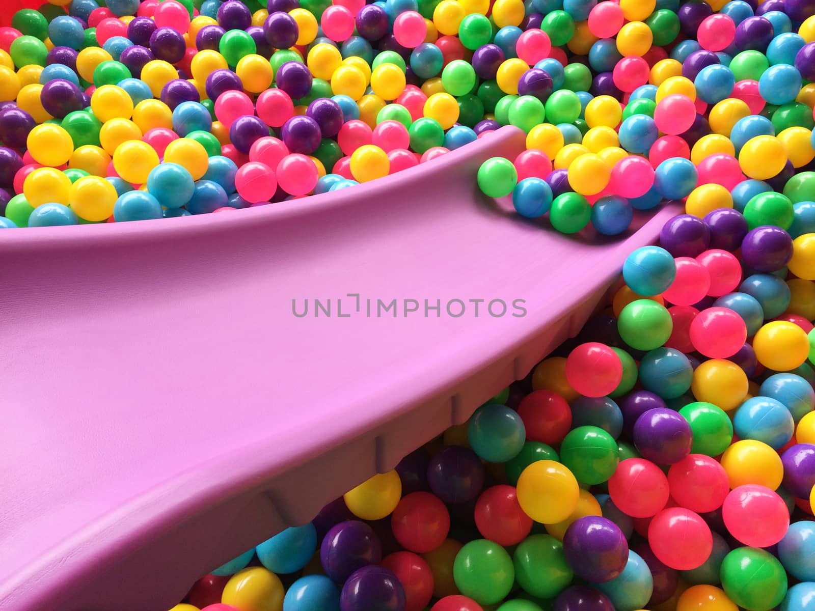 dry children's pool with colorful balls by Bowonpat