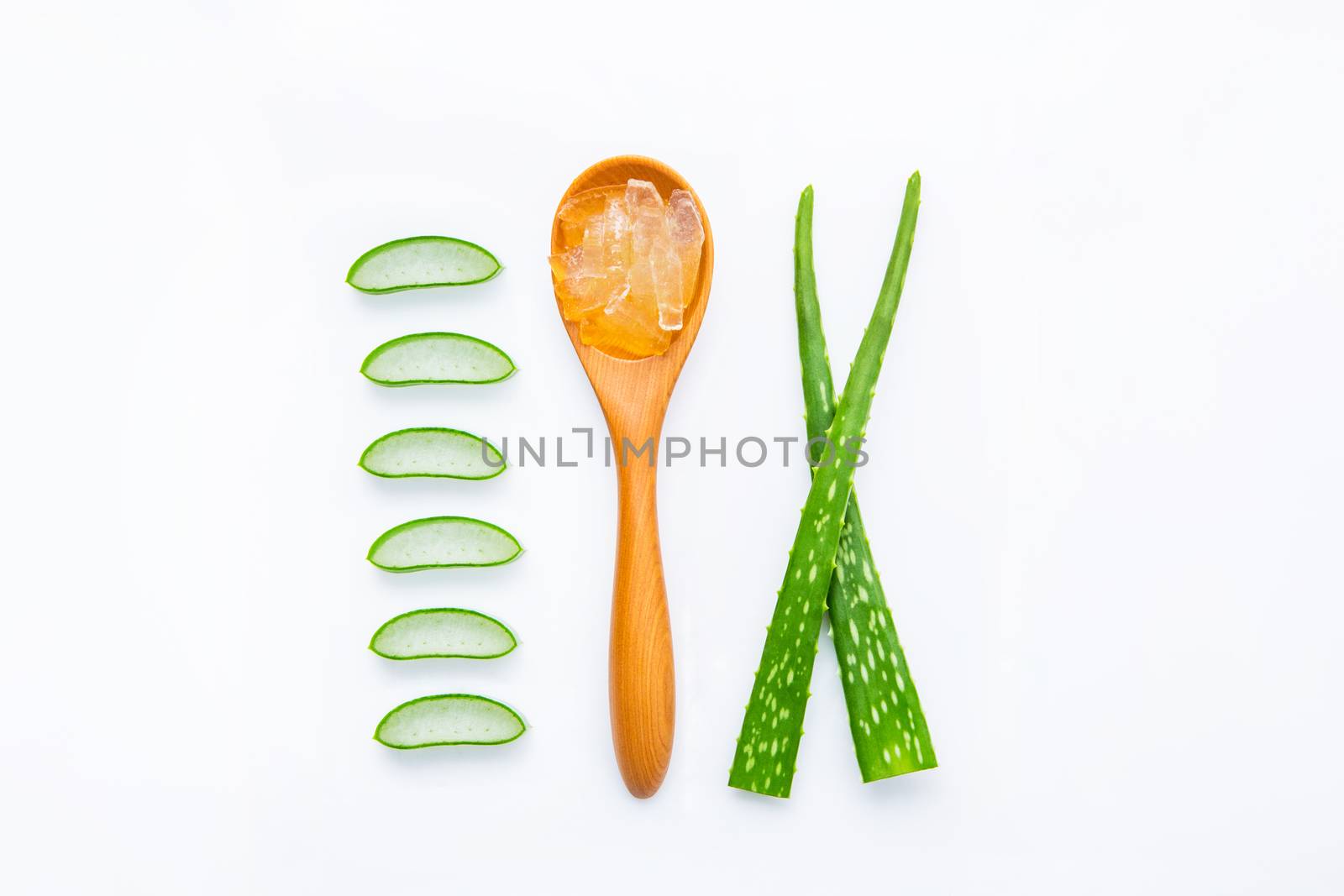 Aloe vera fresh leaves with slices and aloe vera gel on wooden spoon. isolated over white